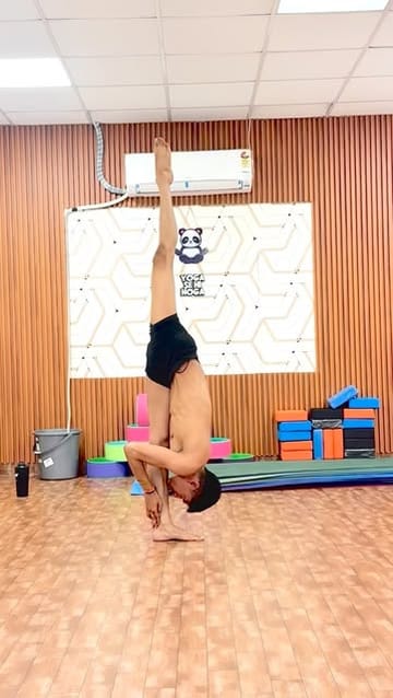 Dalip Singh holding an inversion at the Yoga Se Hoga studio