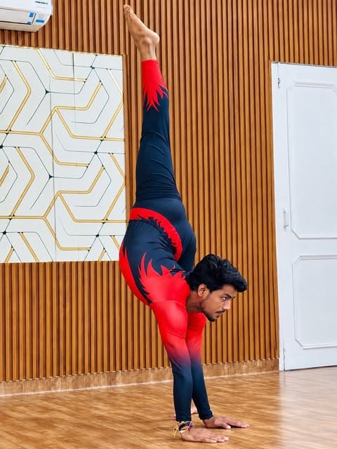 Dev Gohar in a standing split at the studio