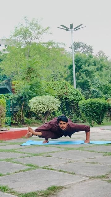 Outdoor arm balance practice in a garden